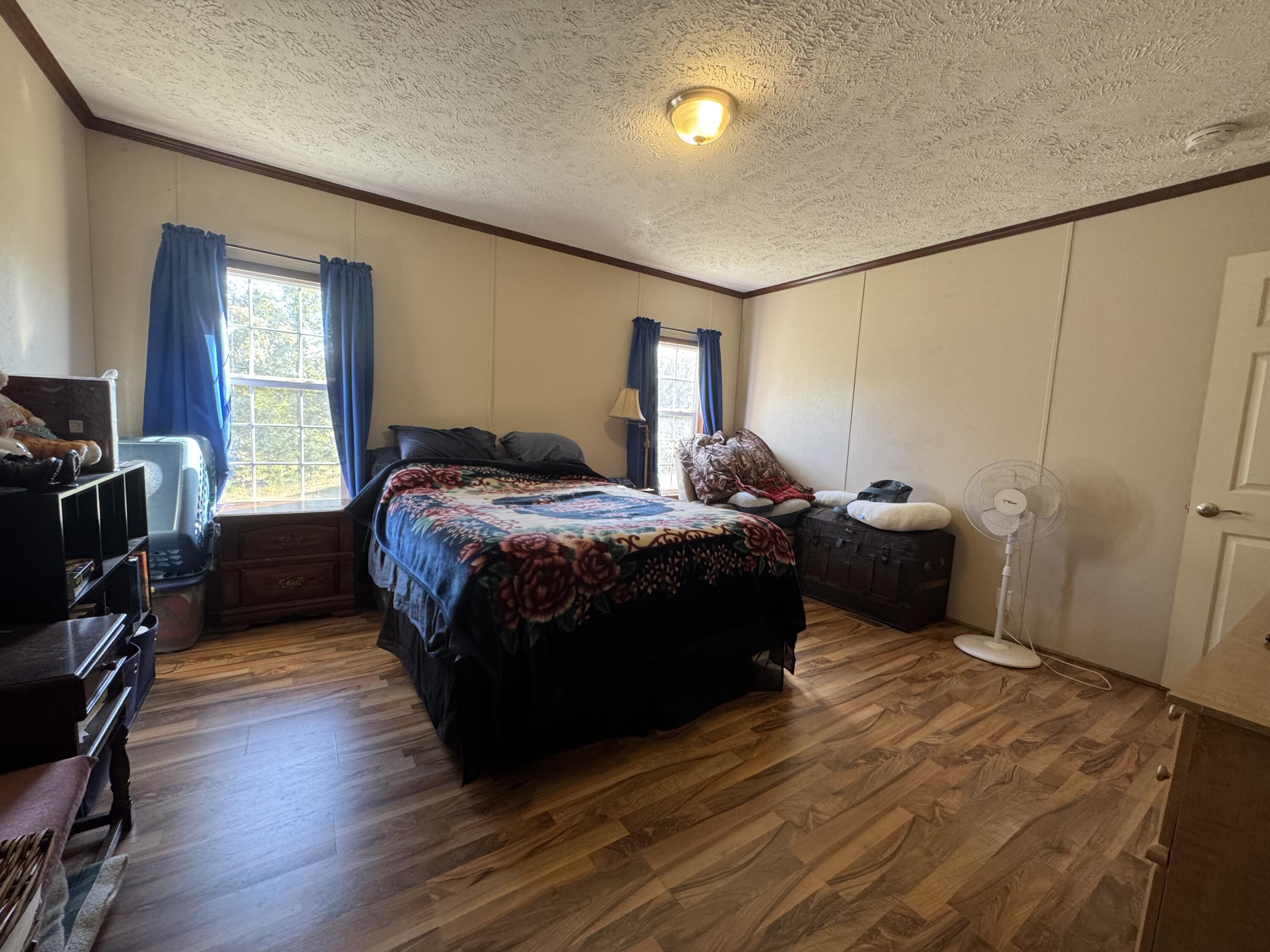 300 White Oak Road Boones Mill, VA 24065 - Photo 5 of 28 a bedroom with a bed a window and wooden floor
