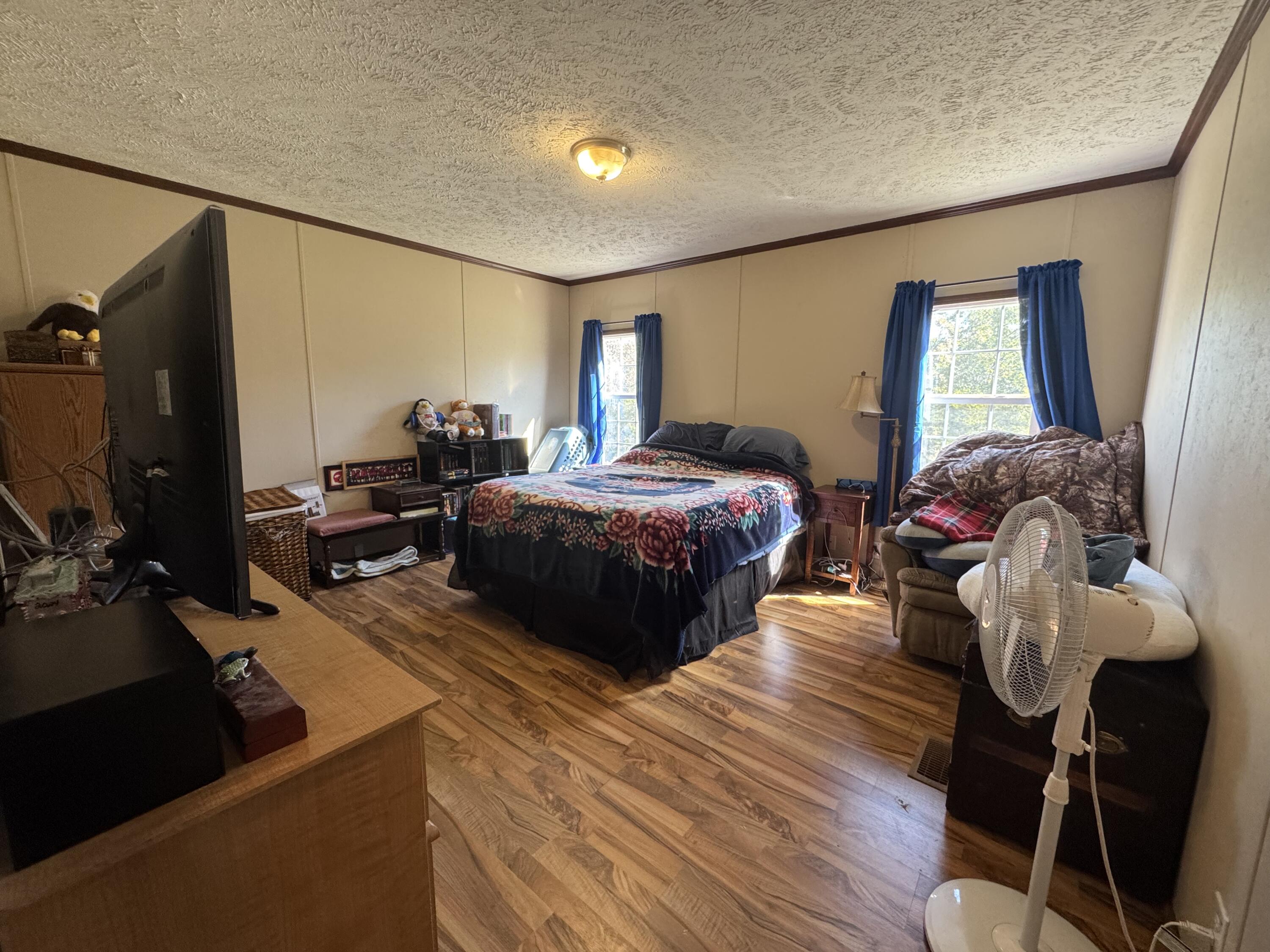 300 White Oak Road Boones Mill, VA 24065 - Photo 6 of 28 a bedroom with a bed and large windows