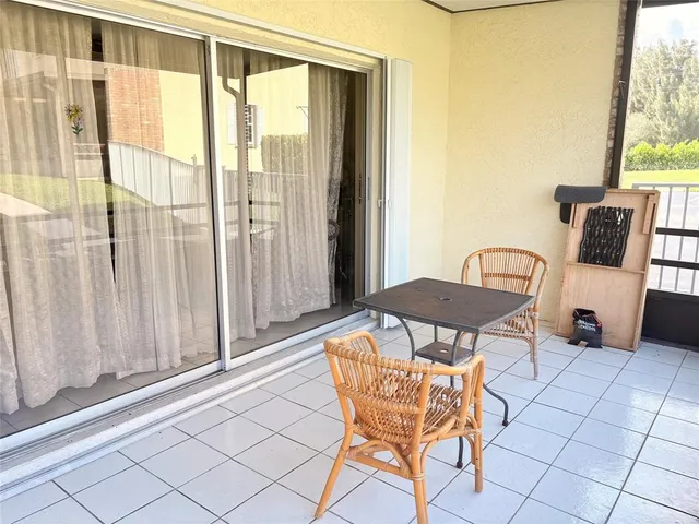 a view of a dining room with furniture and a window