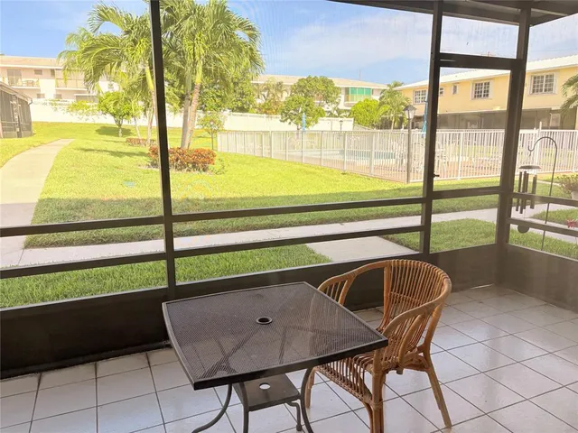 a view of a dining room with furniture and a window