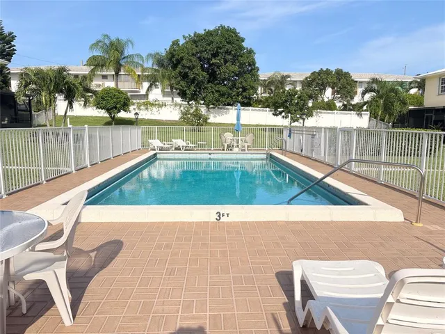 a view of a swimming pool with a lounge chairs