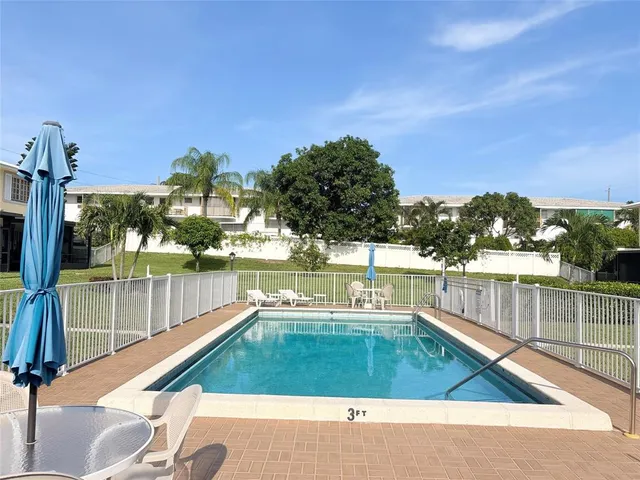 a view of a swimming pool with a patio and mountain view