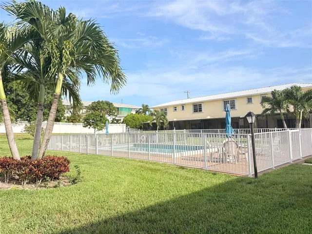 a view of a house with a backyard and a garden