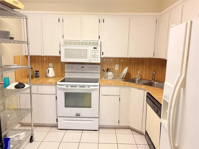 a kitchen with a sink cabinets and appliances