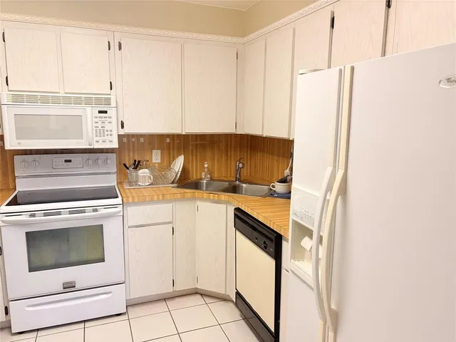 a kitchen with appliances cabinets and a sink