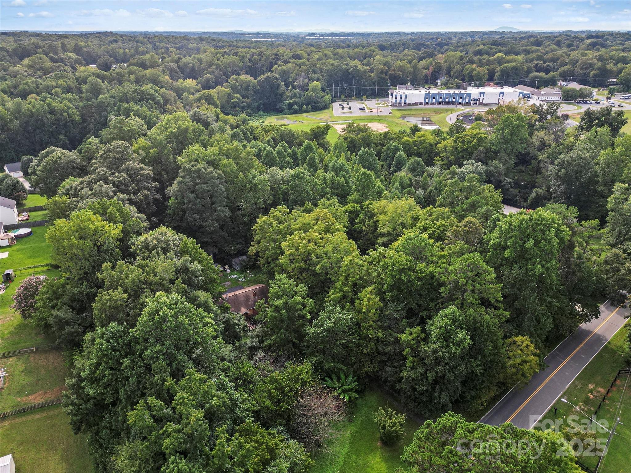 6109 Paw Creek Road Charlotte, NC 28214 - Photo 5 of 18 an aerial view of residential house with outdoor space and trees all around