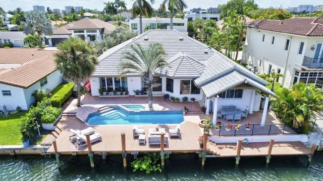 an aerial view of a house with swimming pool patio and outdoor seating