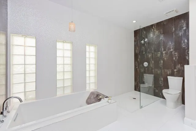 a bathroom with a tub sink and toilet