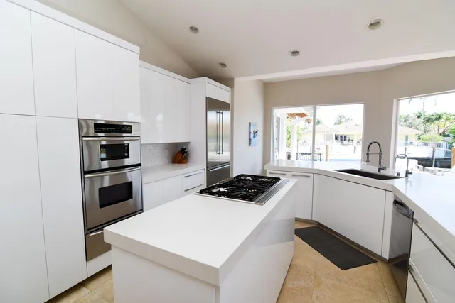 a kitchen with a stove a sink and a refrigerator