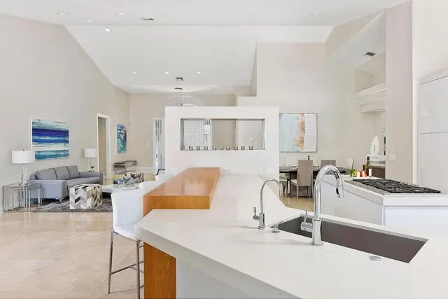 a living room with furniture and a kitchen