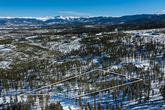 a view of a balcony with a yard and a wooden fence