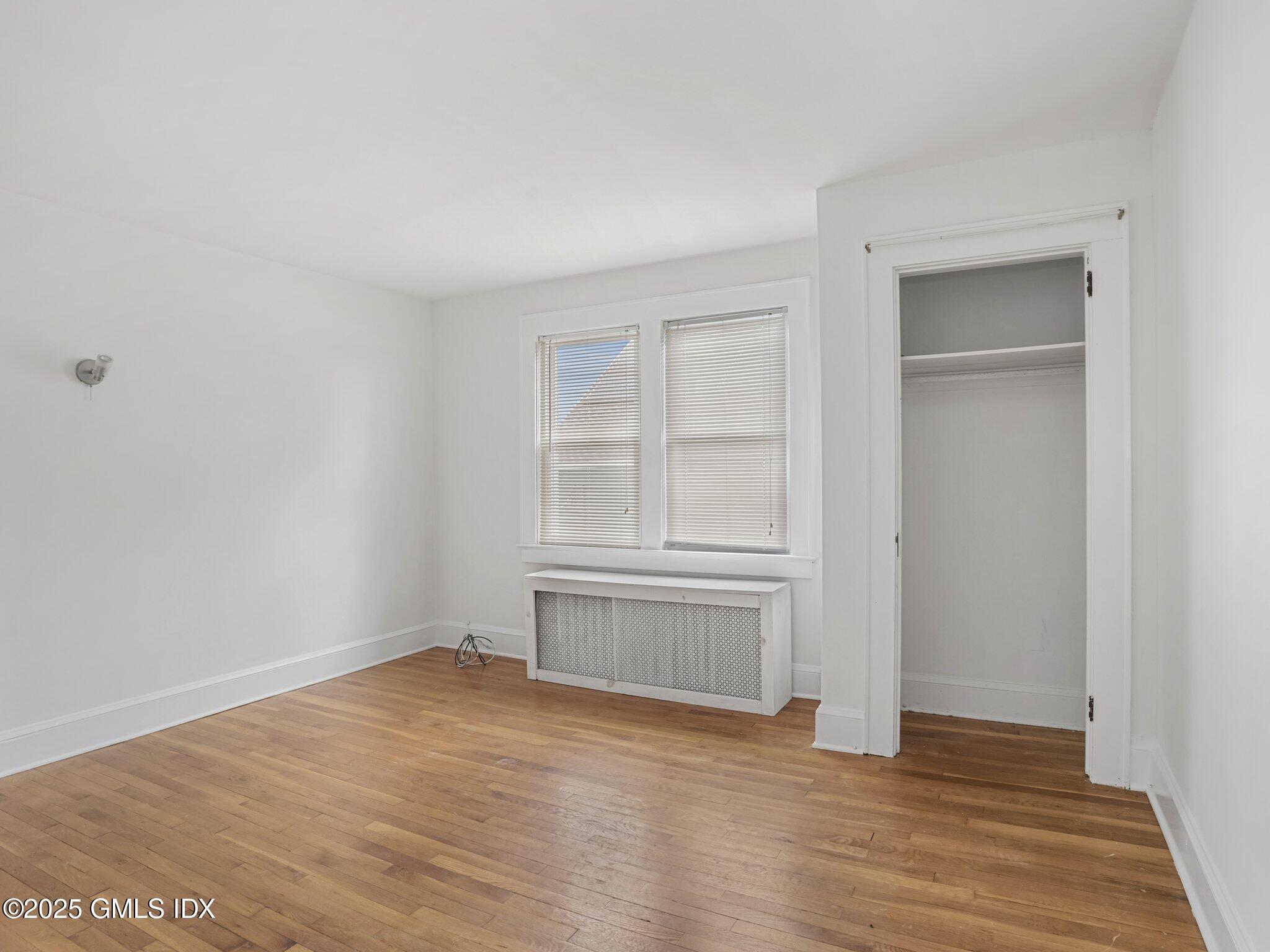 37 High Street, Unit 2 Greenwich, CT 06830 - Photo 13 of 23 an empty room with wooden floor and cabinet