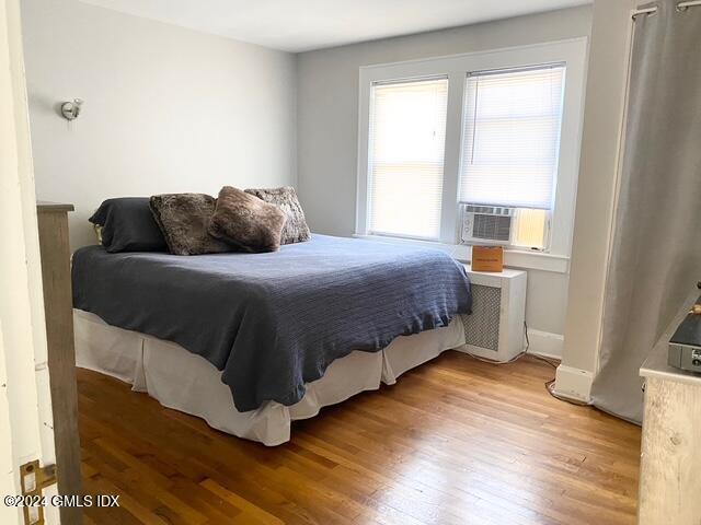 37 High Street, Unit 2 Greenwich, CT 06830 - Photo 14 of 23 a bedroom with a bed and wooden floor