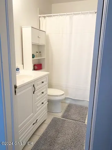 a bathroom with a toilet a sink and a shower