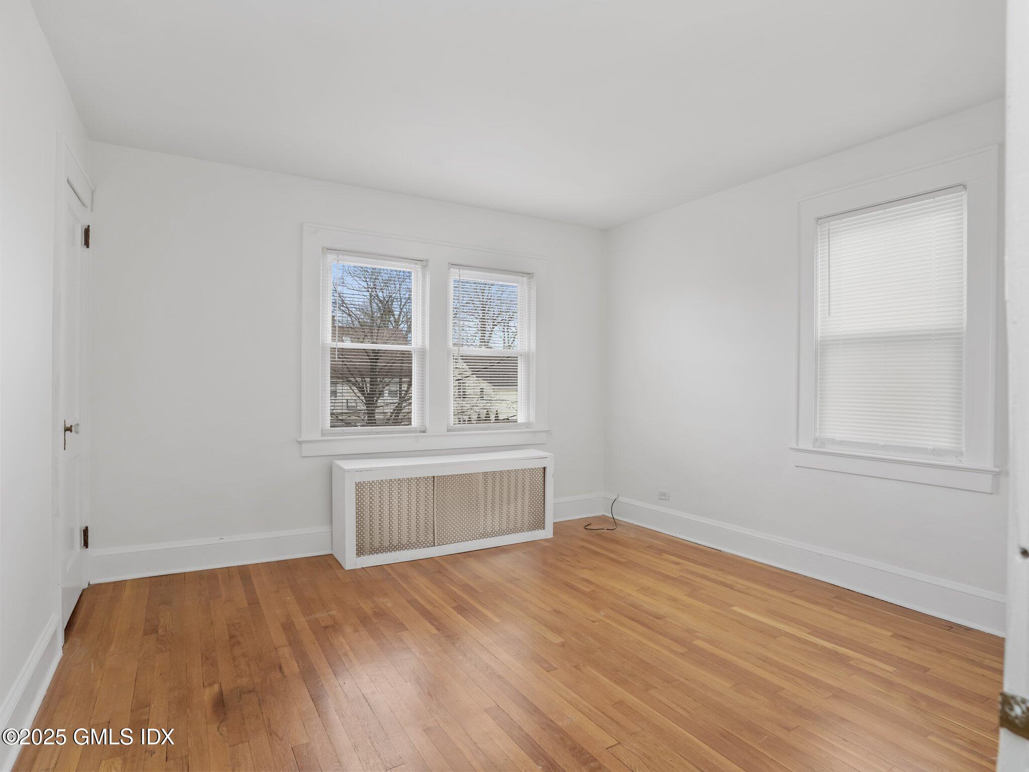37 High Street, Unit 2 Greenwich, CT 06830 - Photo 16 of 23 an empty room with wooden floor and windows