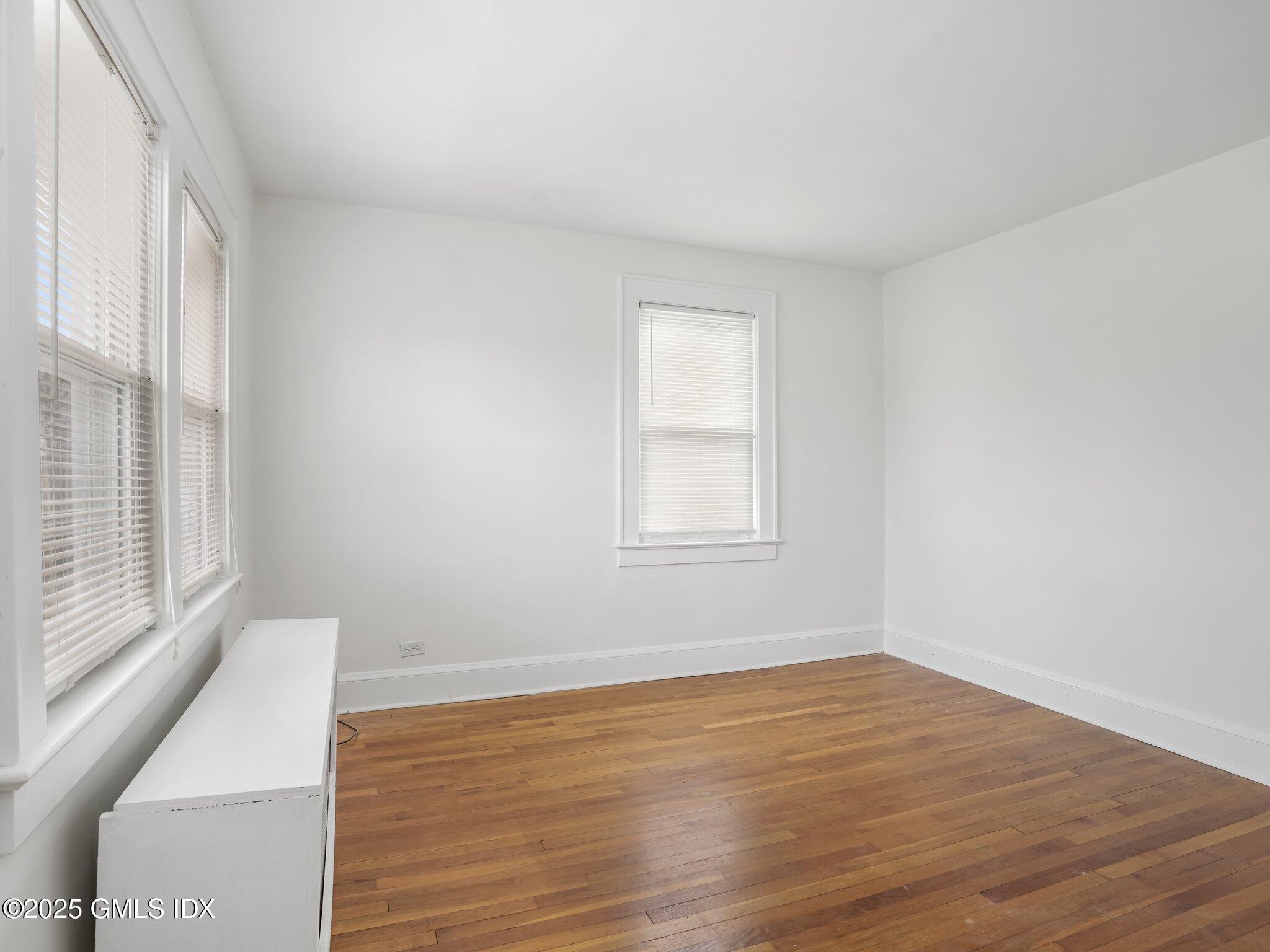 37 High Street, Unit 2 Greenwich, CT 06830 - Photo 18 of 23 a view of an empty room with wooden floor and a window