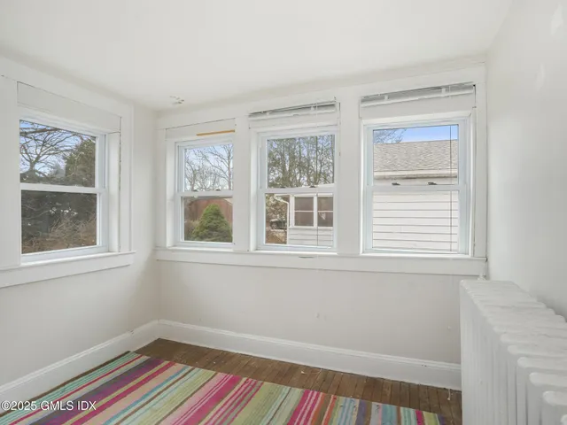 a room that has a window and wooden floor