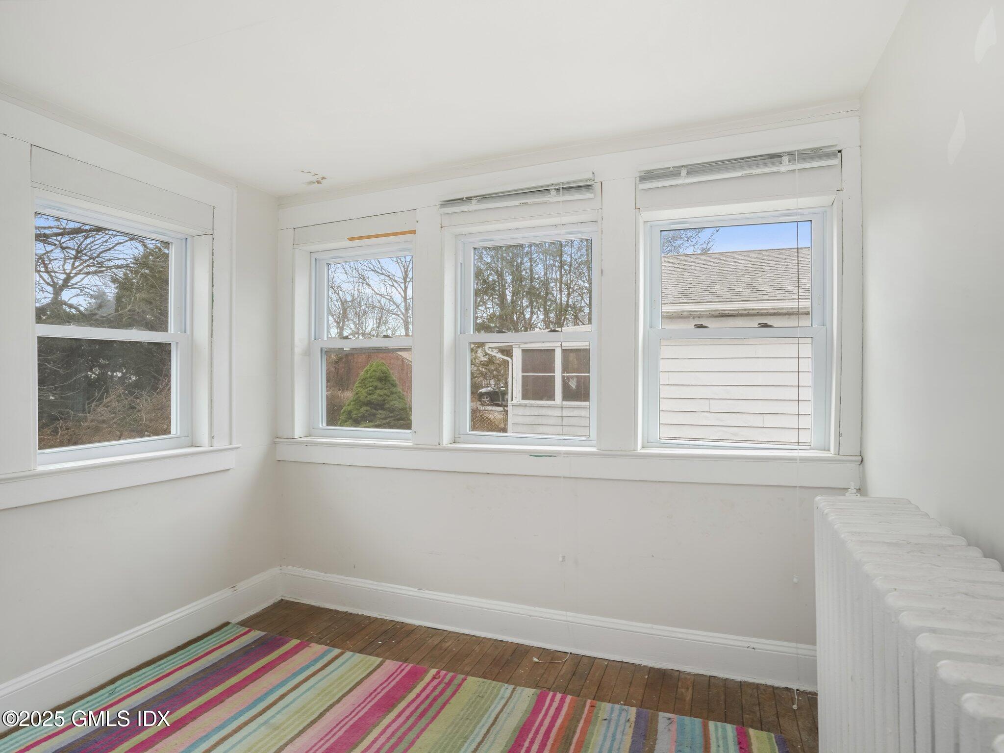 37 High Street, Unit 2 Greenwich, CT 06830 - Photo 19 of 23 a room that has a window and wooden floor