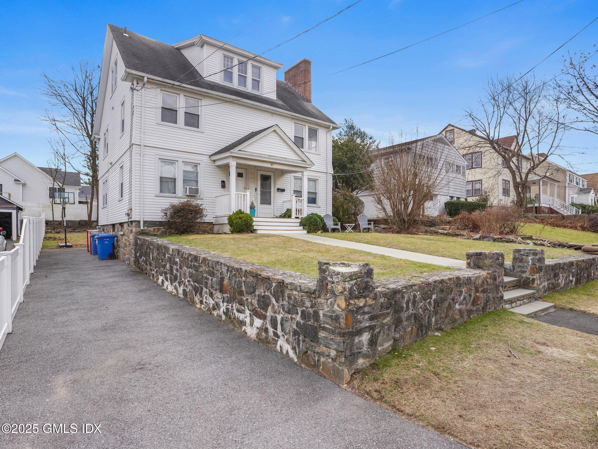 37 High Street, Unit 2 Greenwich, CT 06830 - Photo 2 of 23 a view of a house with a yard