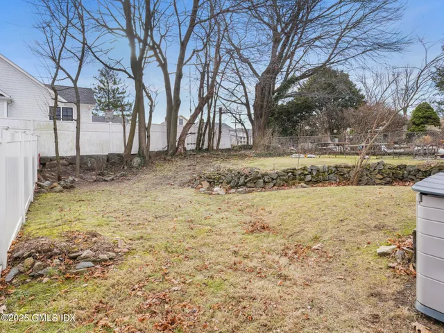 a view of yard covered with snow in front of house