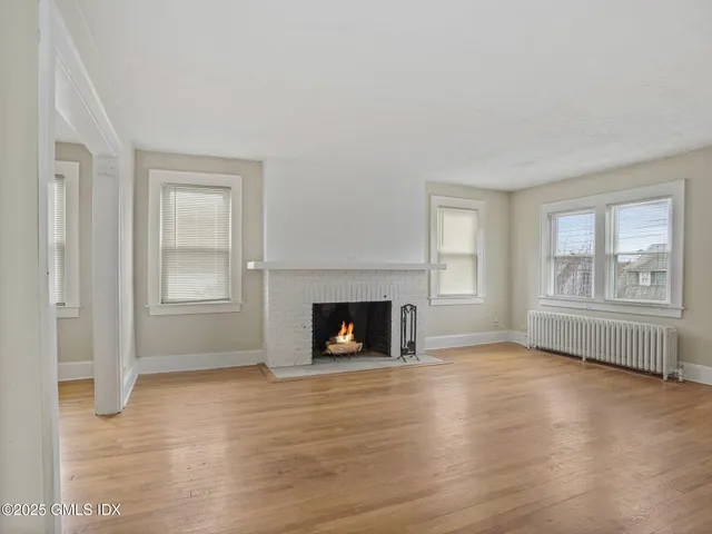 a view of livingroom with furniture fireplace and window