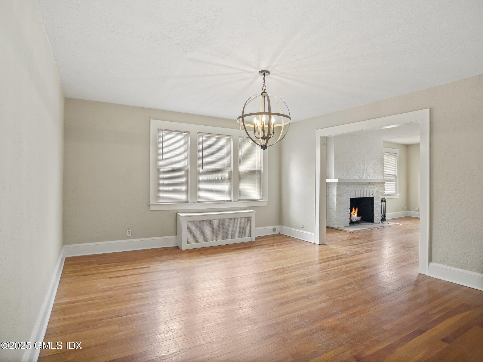 37 High Street, Unit 2 Greenwich, CT 06830 - Photo 7 of 23 an empty room with wooden floor fireplace and windows