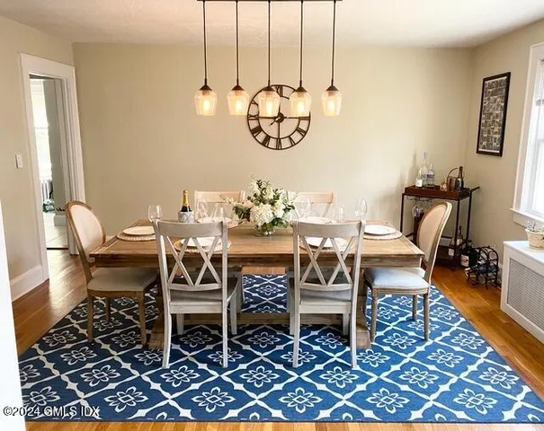 a dining room with furniture a rug and wooden floor