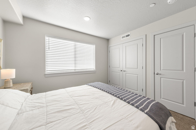 6231 Winding Way, Unit K105 Hurricane, UT 84737 - Photo 12 of 20 Bedroom featuring carpet floors, a textured ceiling, a closet, and recessed lighting
