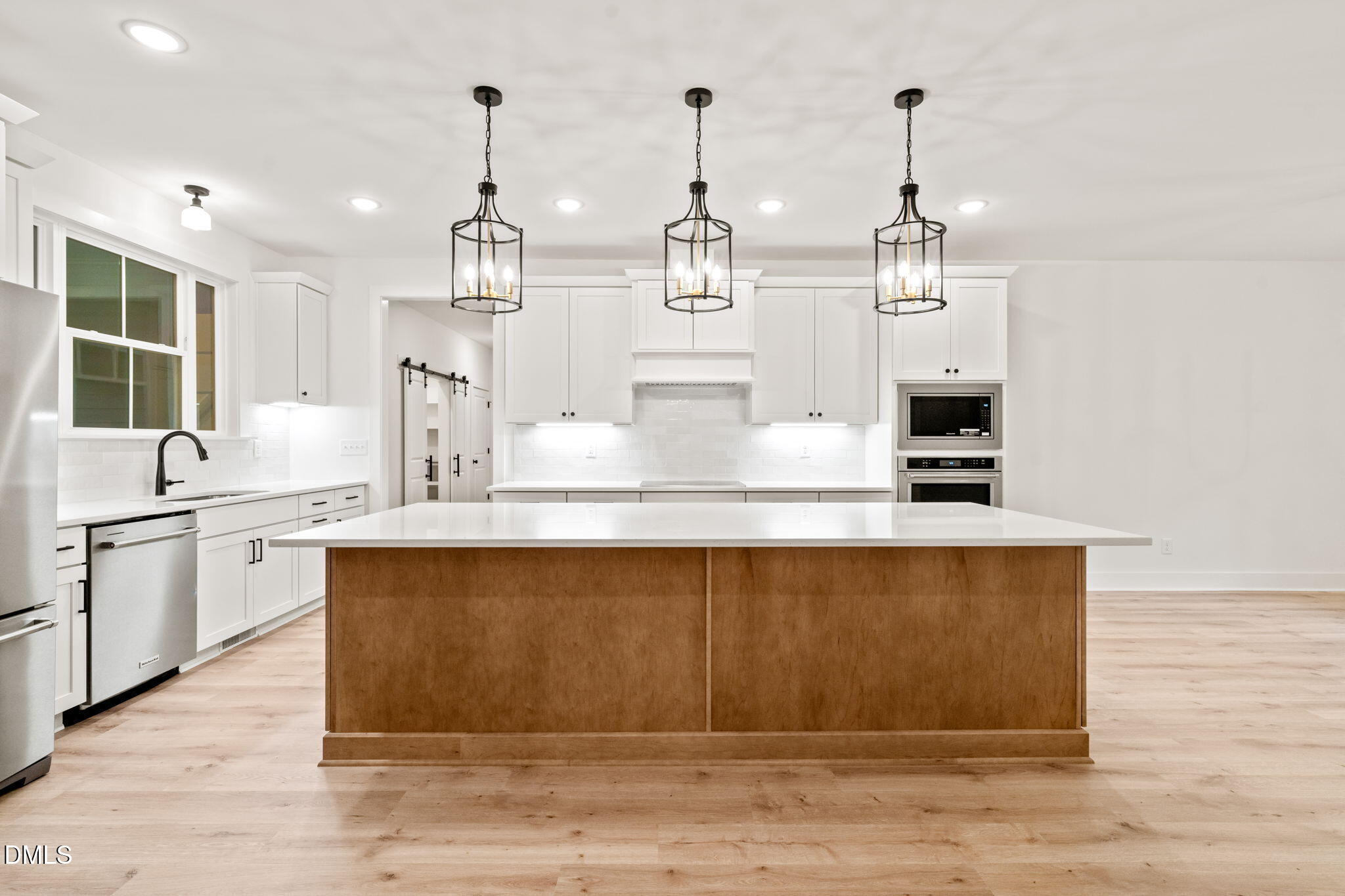 40 Beauview Way Zebulon, NC 27597 - Photo 13 of 52 a large kitchen with kitchen island a sink stainless steel appliances and cabinets