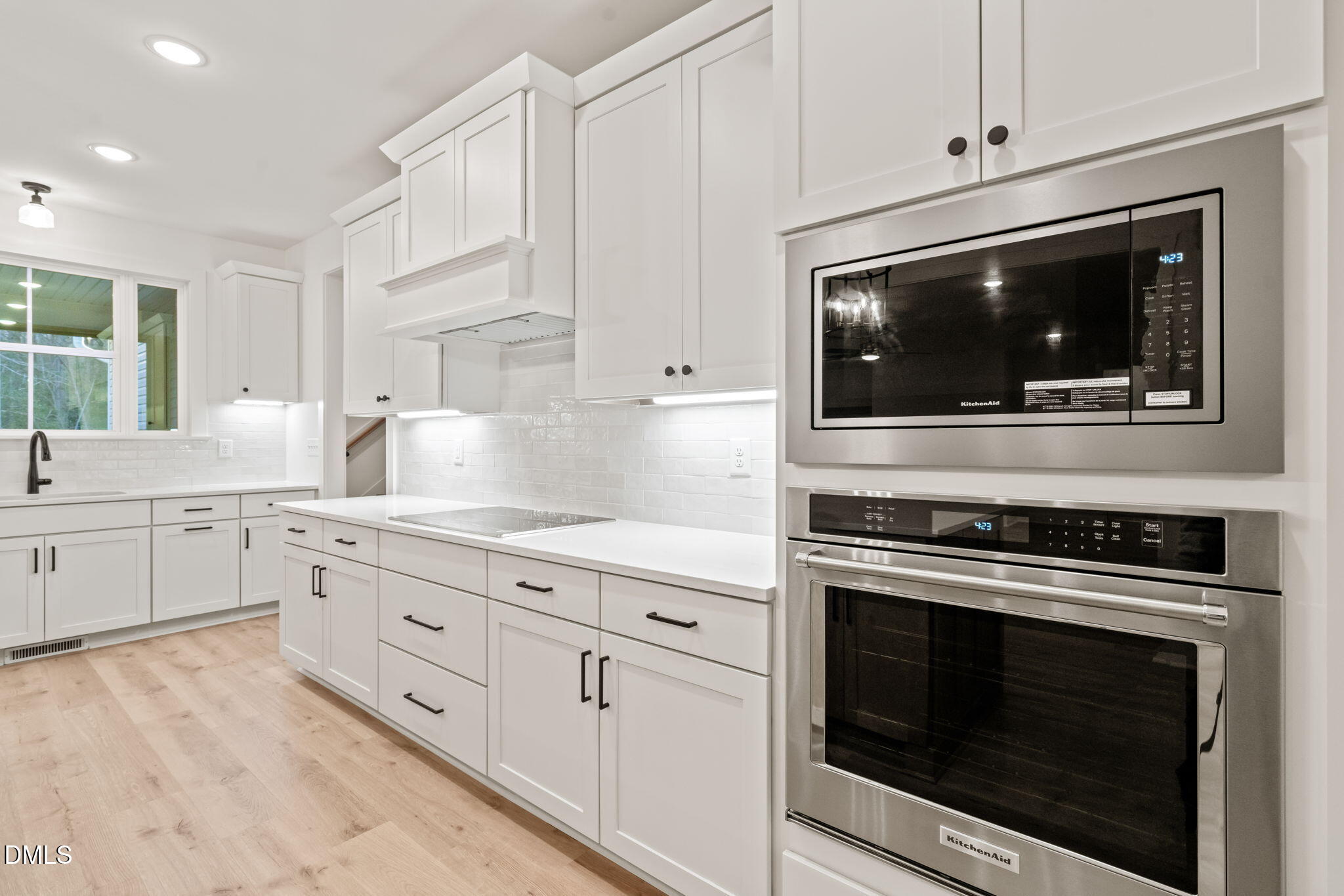 40 Beauview Way Zebulon, NC 27597 - Photo 15 of 52 a kitchen with granite countertop white cabinets stainless steel appliances and sink