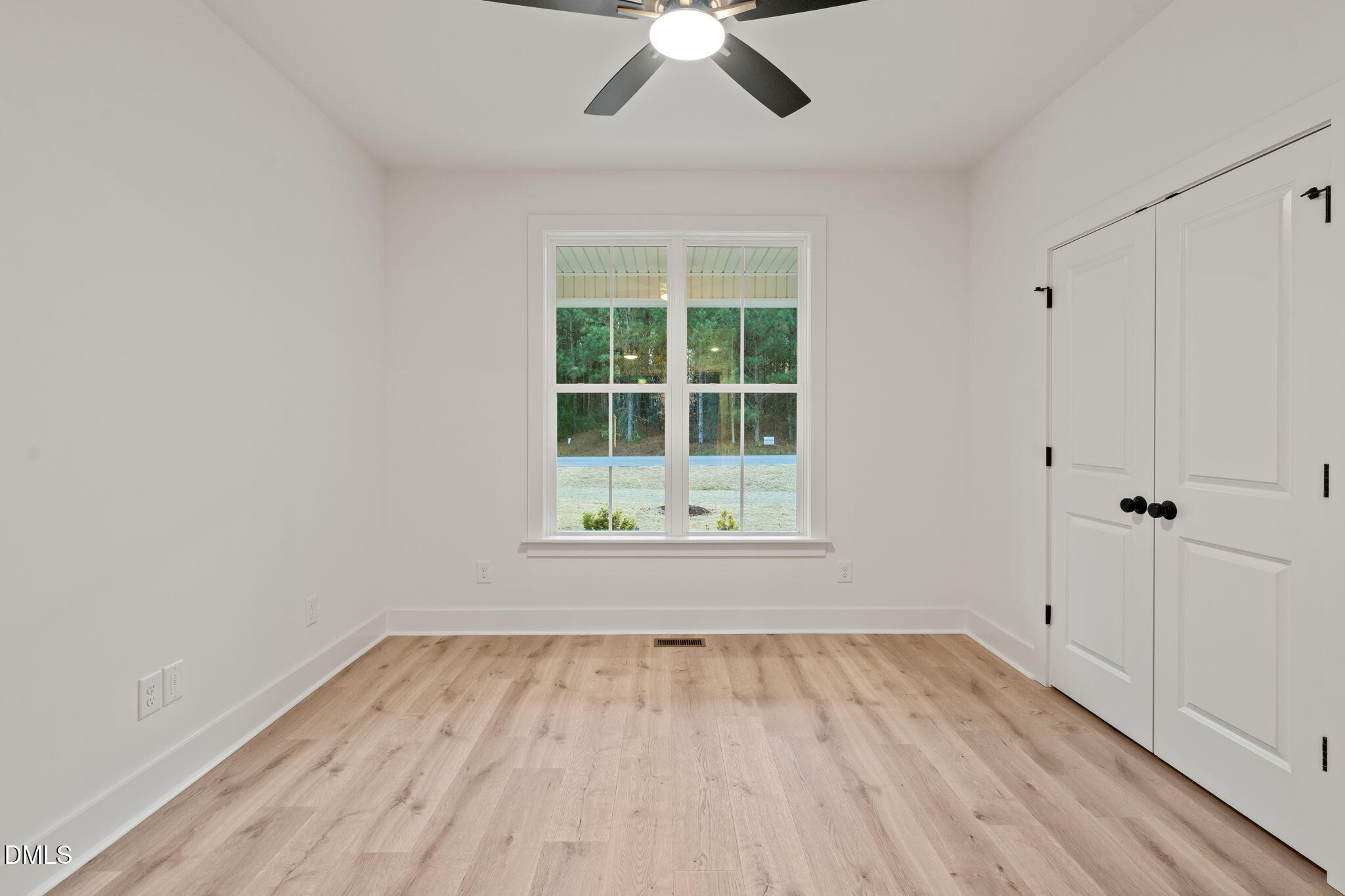 40 Beauview Way Zebulon, NC 27597 - Photo 29 of 52 wooden floor in an empty room with a window