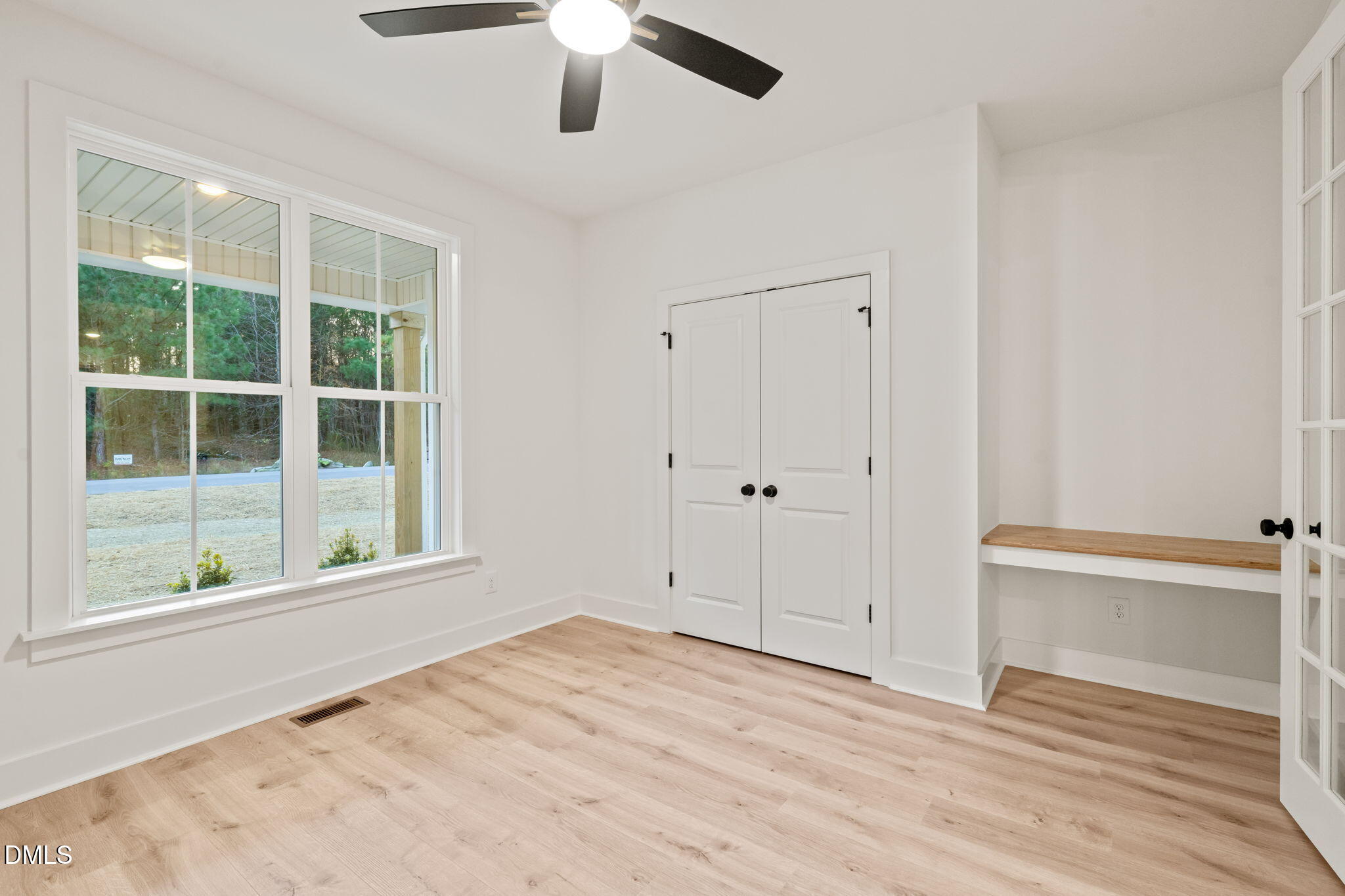 40 Beauview Way Zebulon, NC 27597 - Photo 30 of 52 a view of an empty room with a window and wooden floor