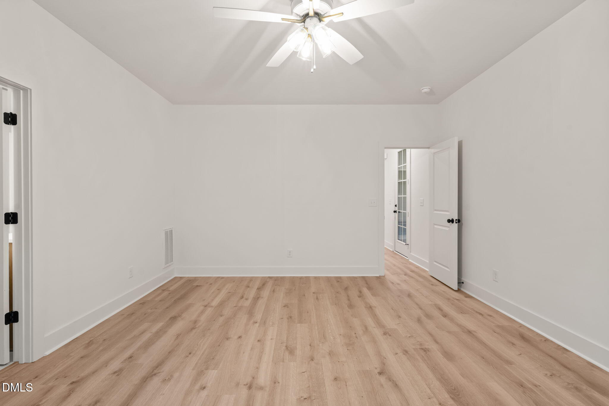 40 Beauview Way Zebulon, NC 27597 - Photo 32 of 52 a view of an empty room with wooden floor and a ceiling fan