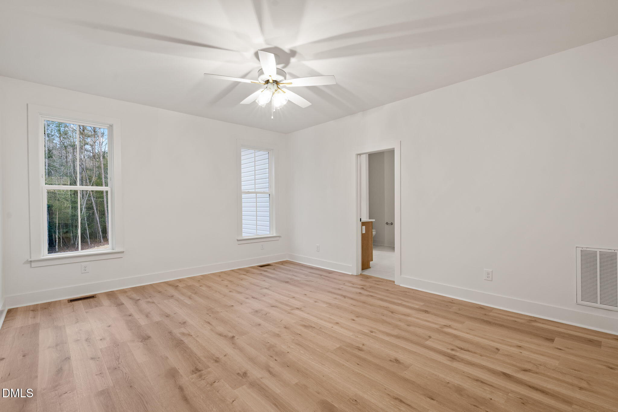 40 Beauview Way Zebulon, NC 27597 - Photo 33 of 52 a view of an empty room with wooden floor and a window