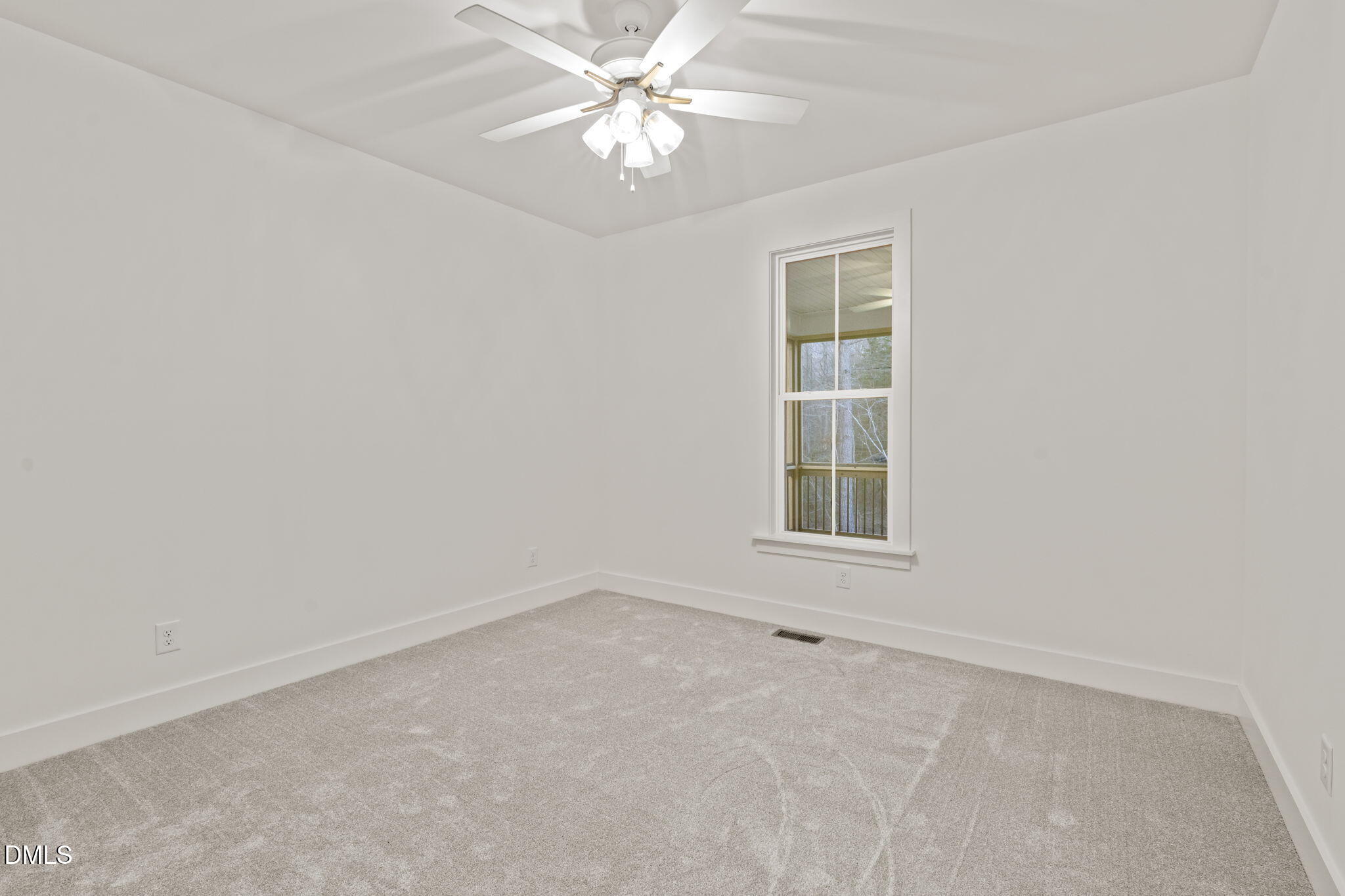 40 Beauview Way Zebulon, NC 27597 - Photo 41 of 52 an empty room with a window and a fan