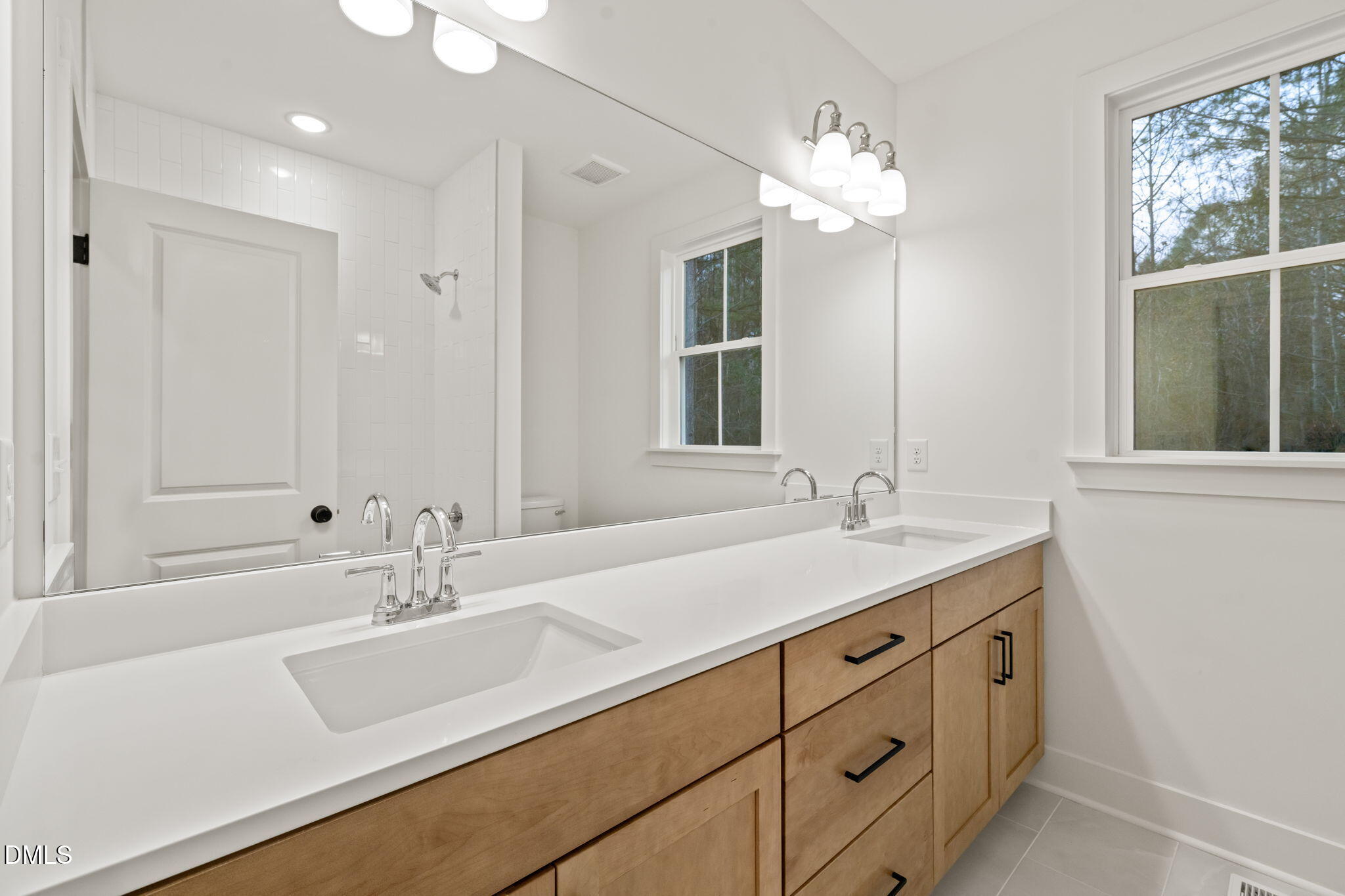 40 Beauview Way Zebulon, NC 27597 - Photo 42 of 52 a bathroom with a sink double vanity and a mirror