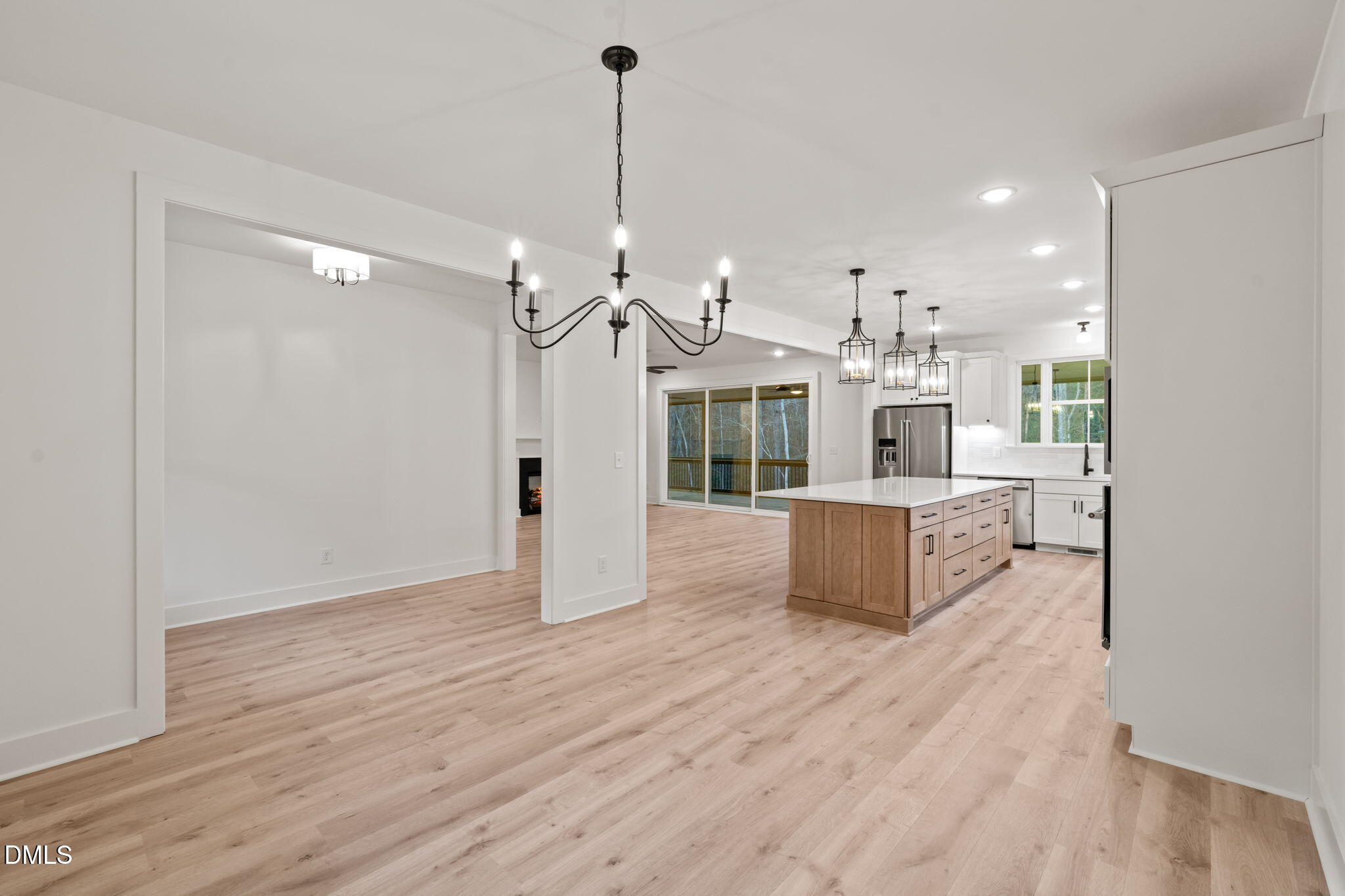 40 Beauview Way Zebulon, NC 27597 - Photo 9 of 52 a view of a living room and kitchen with stainless steel appliances