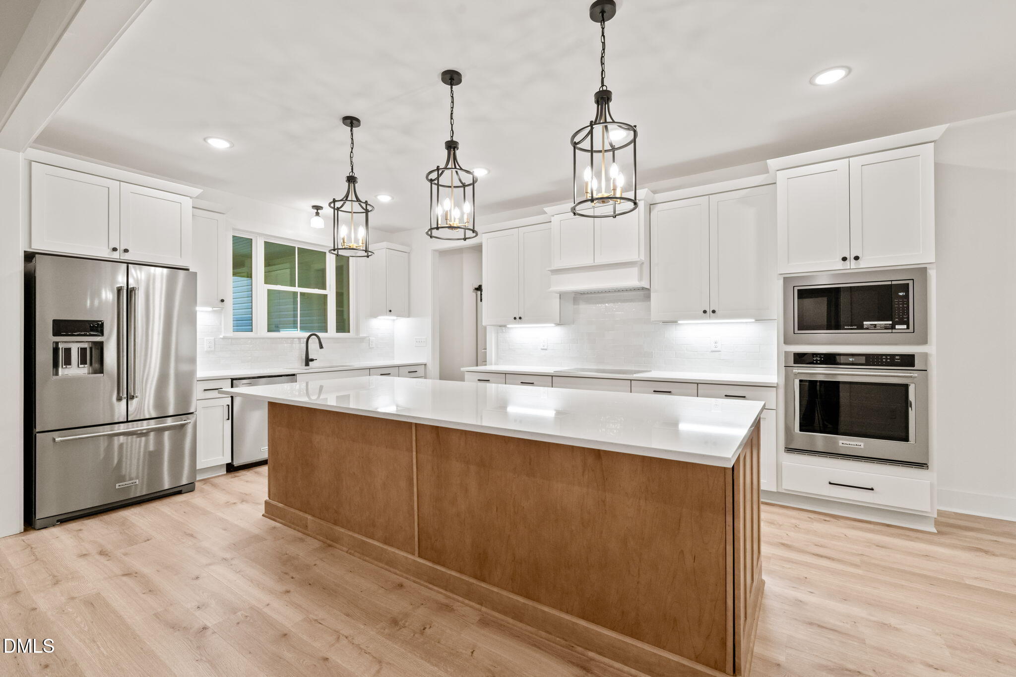 40 Beauview Way Zebulon, NC 27597 - Photo 10 of 52 a kitchen with stainless steel appliances granite countertop a refrigerator a stove a sink and white cabinets
