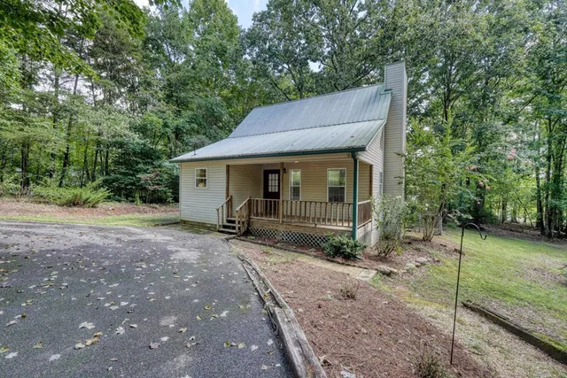 a house that has a tree in front of it