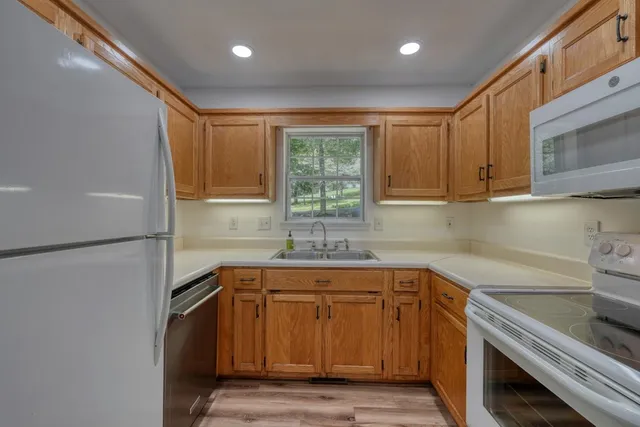 a kitchen with a sink appliances and cabinets