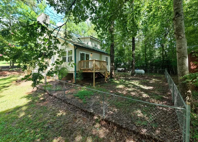 a backyard of a house with table and chairs