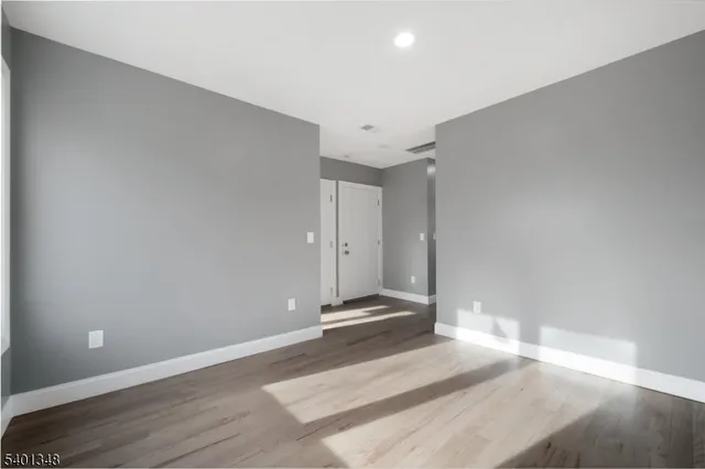 a view of a room with wooden floor