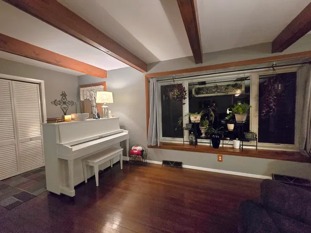 a room with wooden floors table tennis and arcade game machine