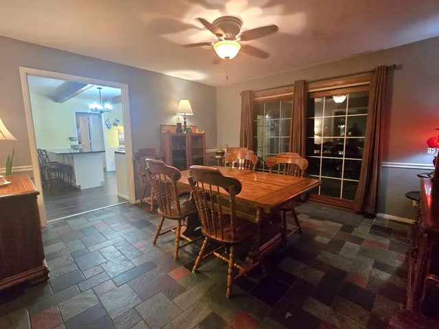 a view of a dining room with furniture and chandelier