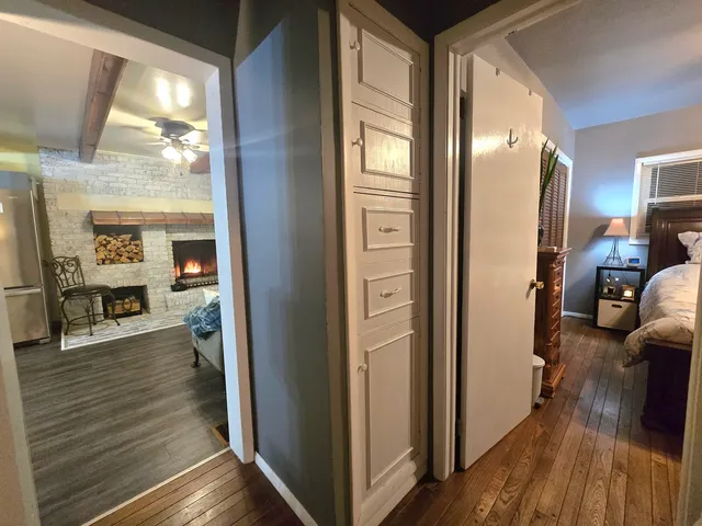 a view of a hallway view with wooden floor and furniture