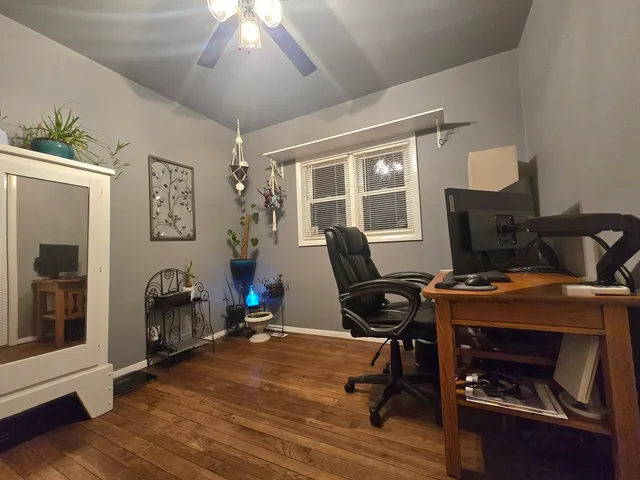 a view of a workspace with furniture and a window