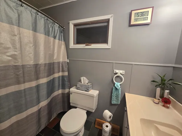 a bathroom with a toilet sink and mirror