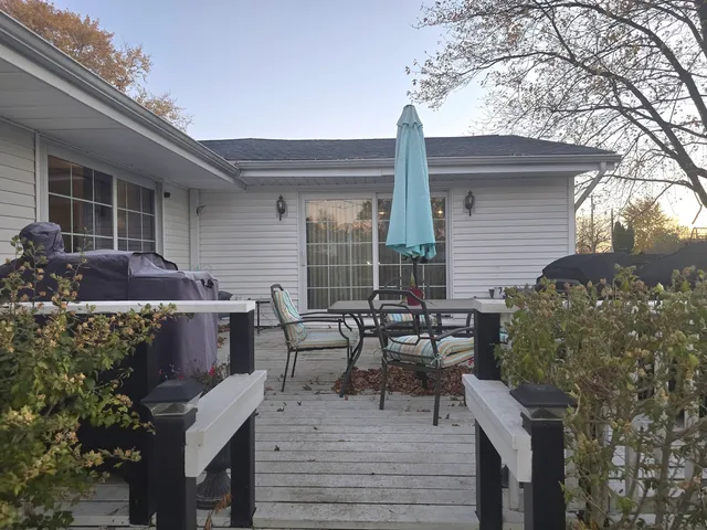 a backyard of a house with table and chairs