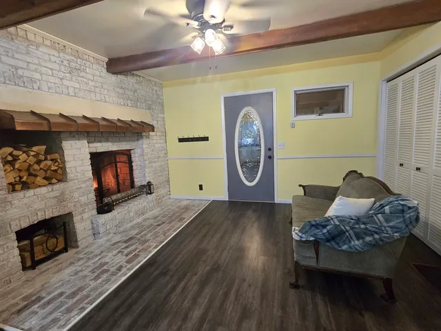 a living room with furniture and a fireplace