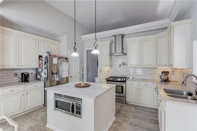 a kitchen with a sink stove and refrigerator